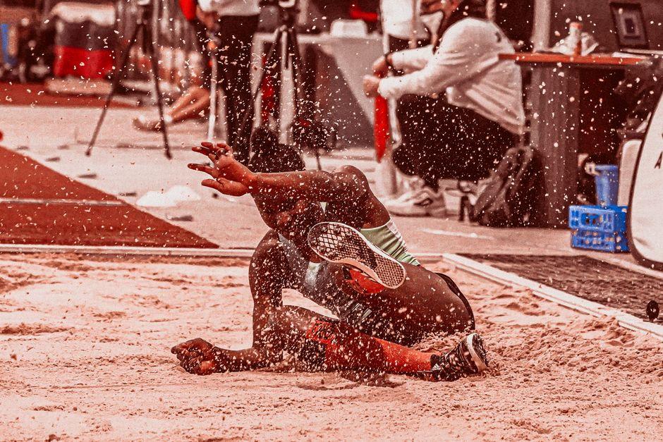 Woman Landing on Sand After Doing Long Jump