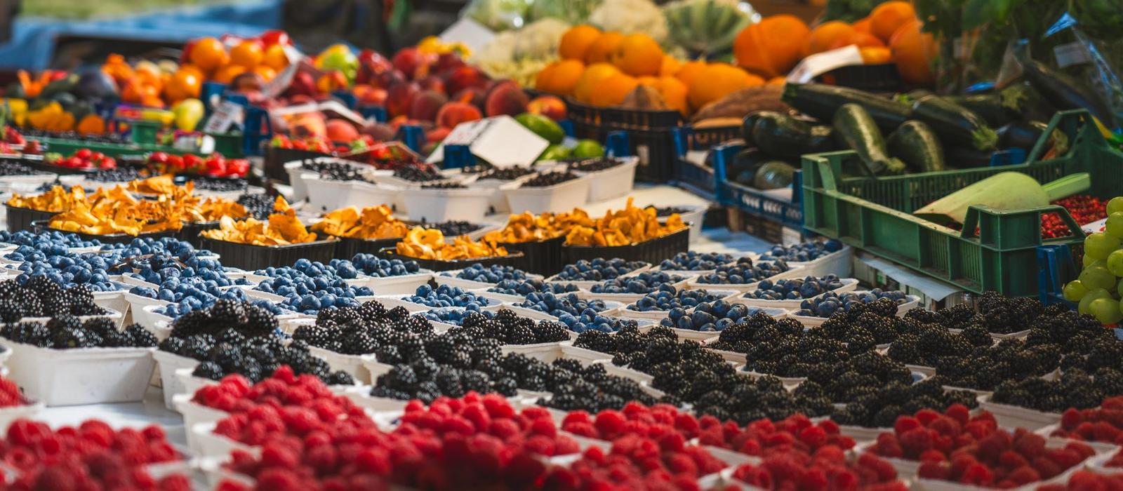 Vibrant Market Stall with Fresh Berries and Vegetables